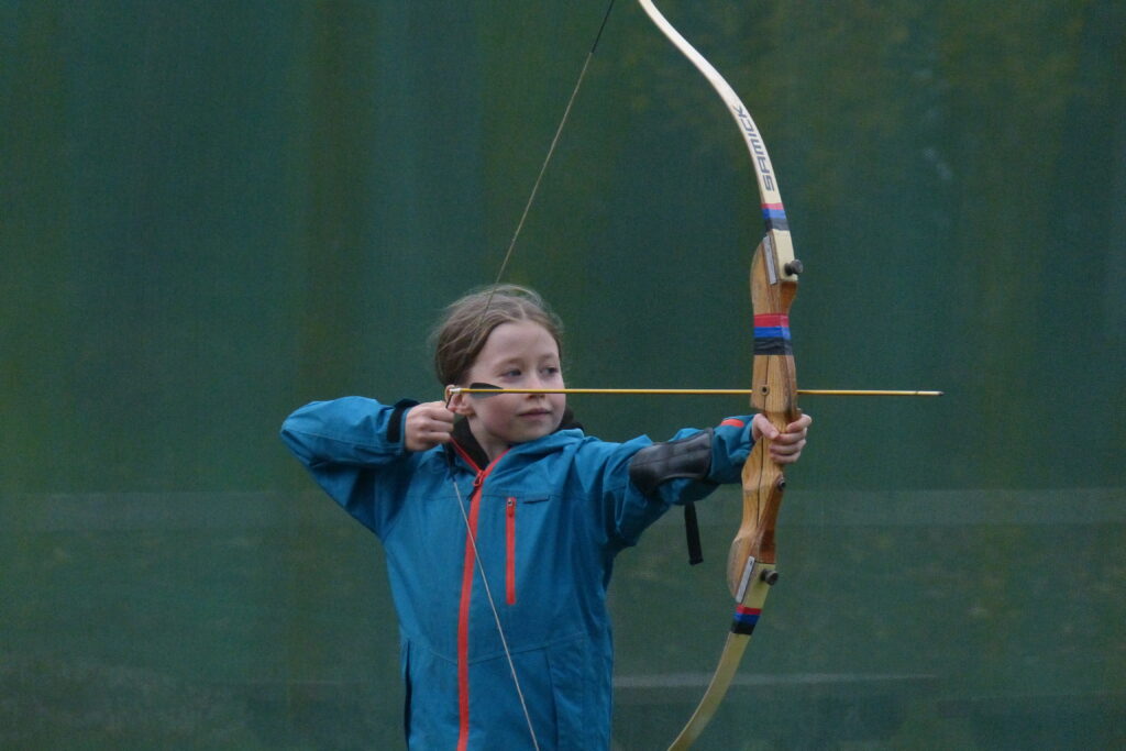 A cub holding a bow-and-arrow